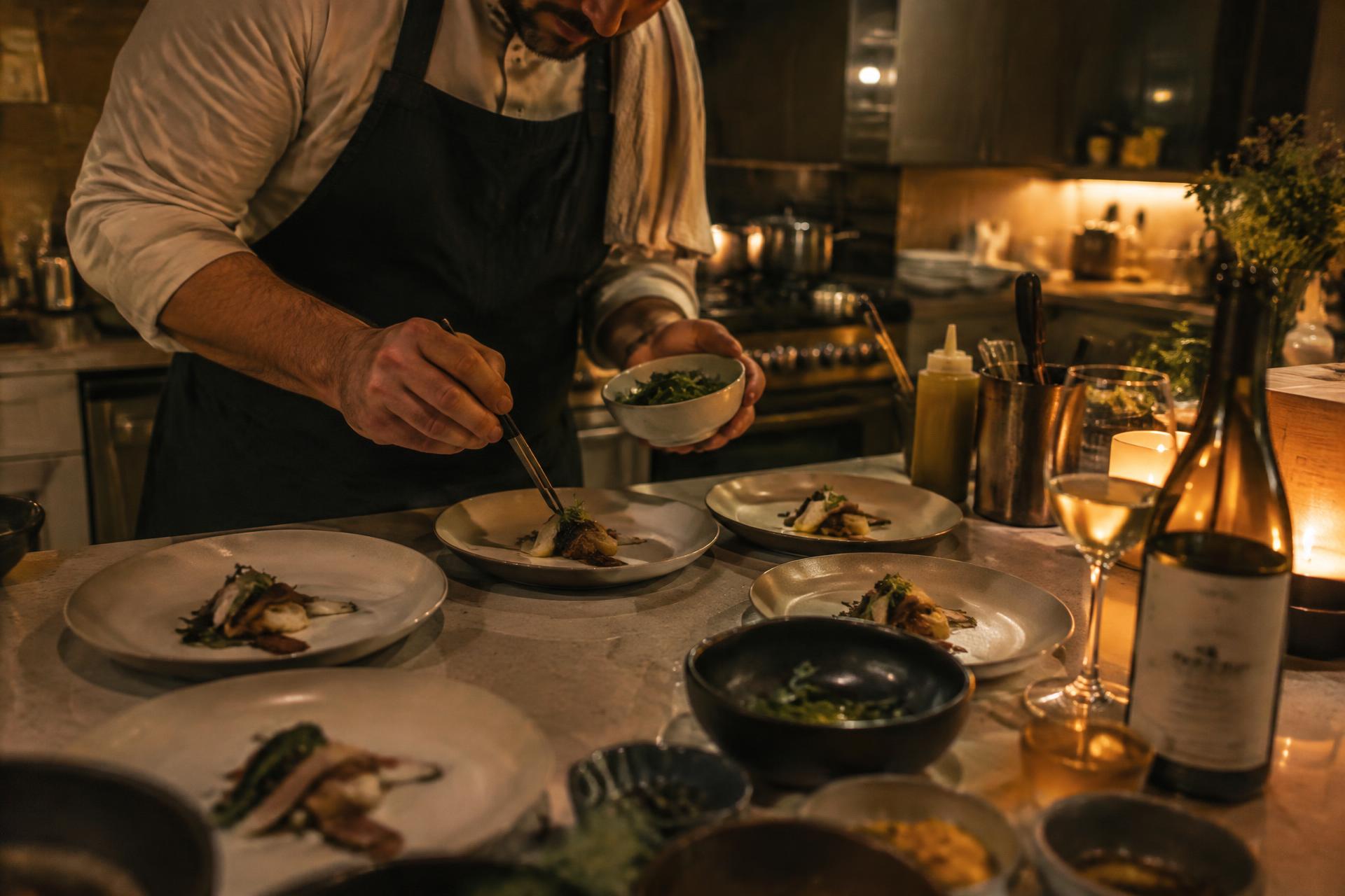 Chef plating a seasonal dish at a private dinner