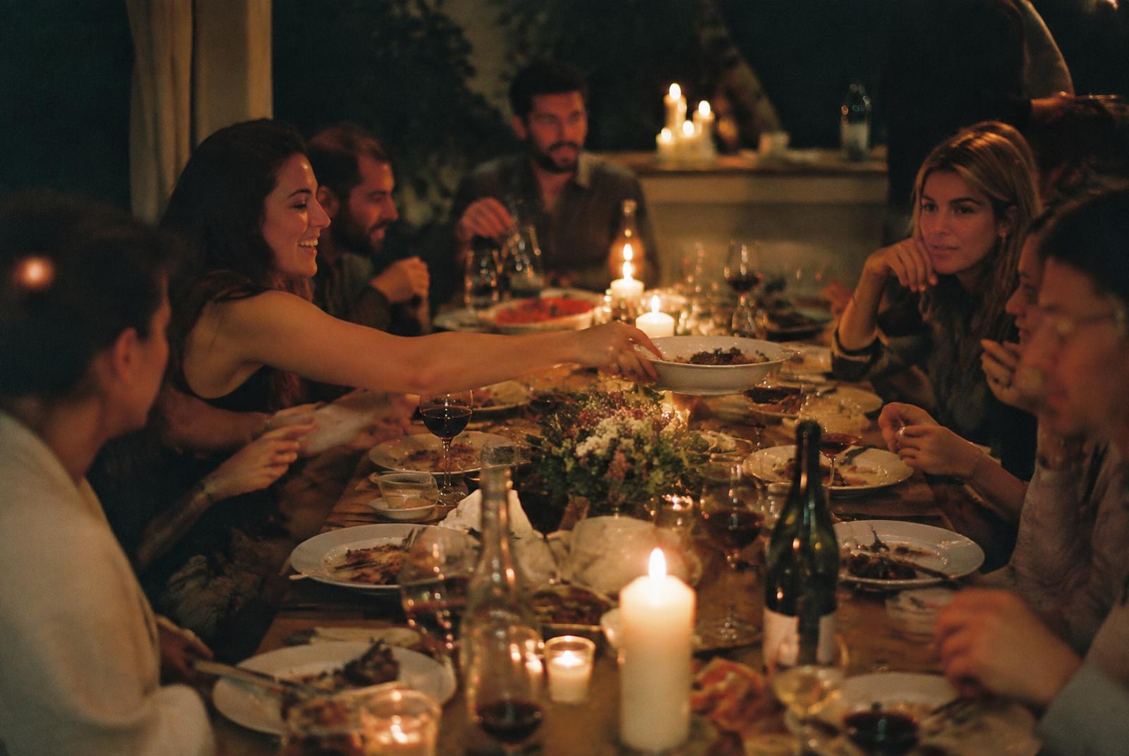 Guests around a candlelit table